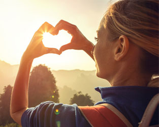 woman making a heart with her hands