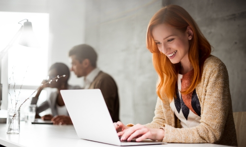 Employees sitting at a desk and working