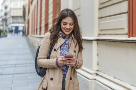 A girl using her phone to apply for a checking account