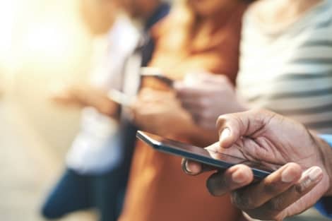 A group of people using mobile banking on their phones